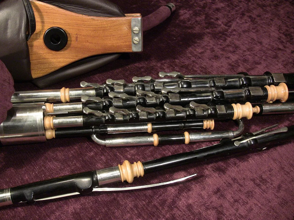 A set of uilleann pipes laid out showing the bag, the bellows and the chanter with its keys
